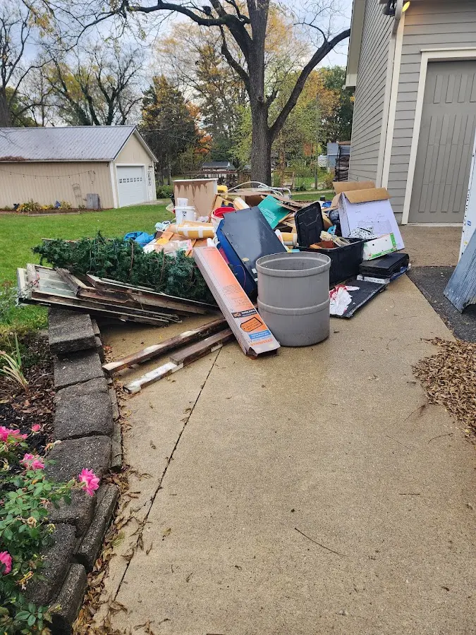 Dumpster being loaded with debris for Estate Cleanout Dumpster Rental in Turtle Creek